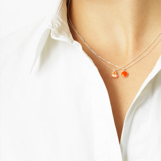 Sign necklace with pendant. Neon orange. Sterling silver. Scherning Copenhagen