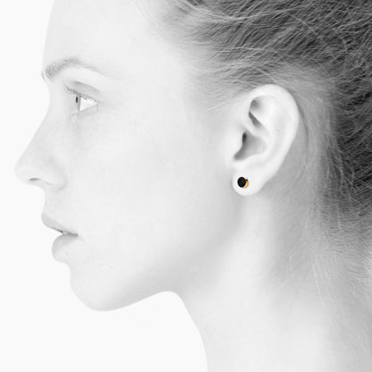 Sign earrings for him and her. Black and gold. Gold-plated sterling silver. Scherning Copenhagen